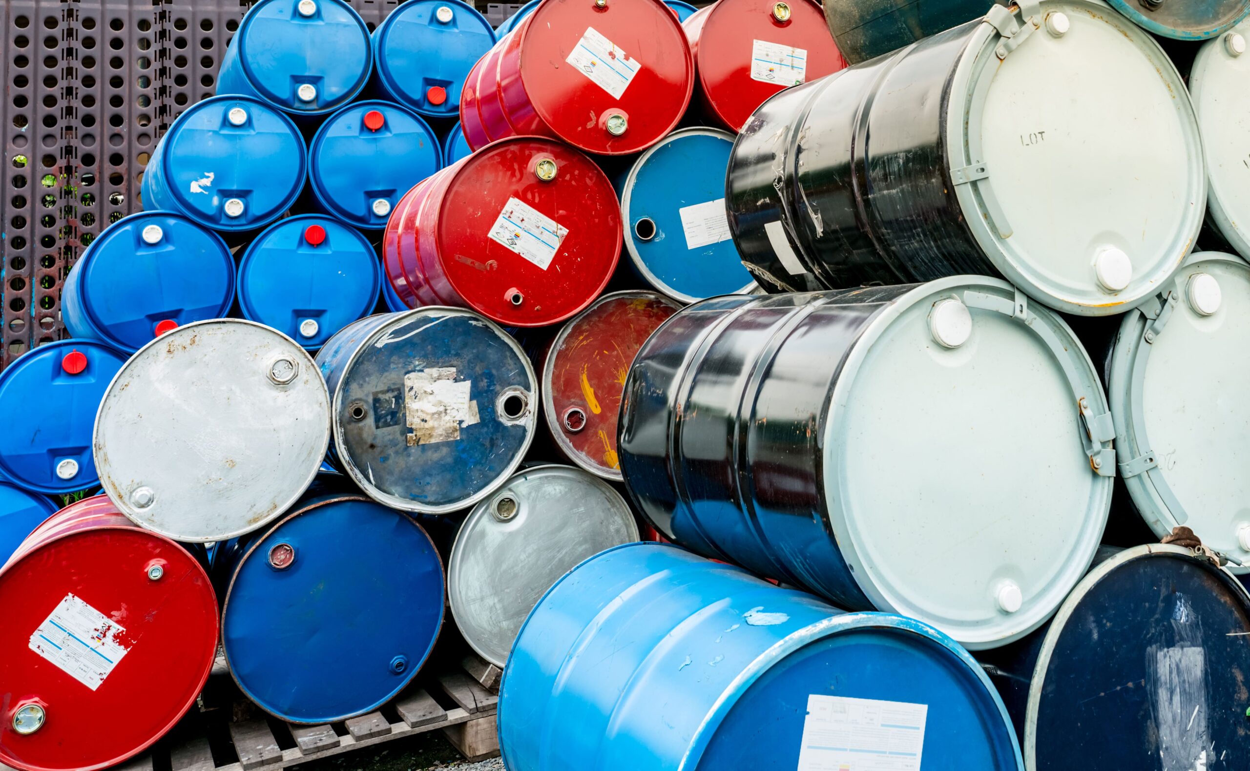 old-chemical-barrels-on-wooden-pallet-blue-and-re-2026-03-18-04-35-24-utc (1)
